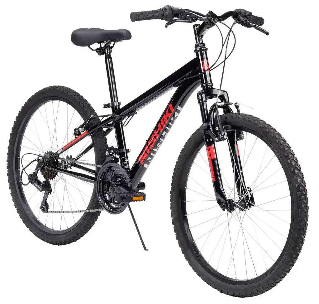 Nishiki Pueblo 24-inch kids mountain bike in black with red accents, featuring front suspension and knobby tires for off-road riding.