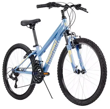 Nishiki Pueblo 24-inch kids mountain bike in light blue with yellow graphics, front suspension, and durable mountain tires.